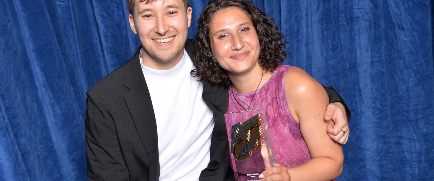 Two people holding award